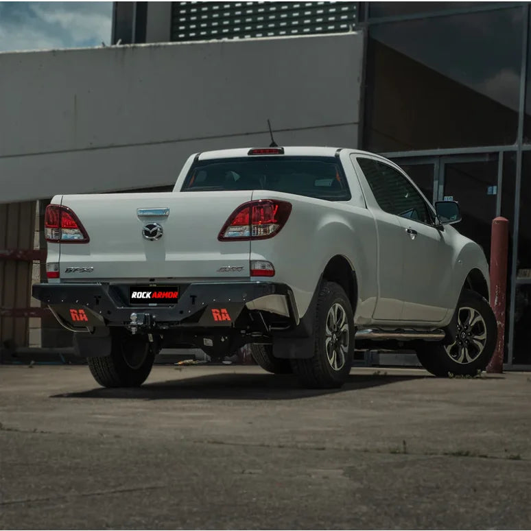 White Mazda BT-50 pickup truck showing the back side with rockamor elite steel rear step and towbar installation