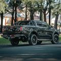 Black pickup truck rear showing rockarmor elite steel rear step and elite rear tow bar for mitsubishi triton mq 2015-2018