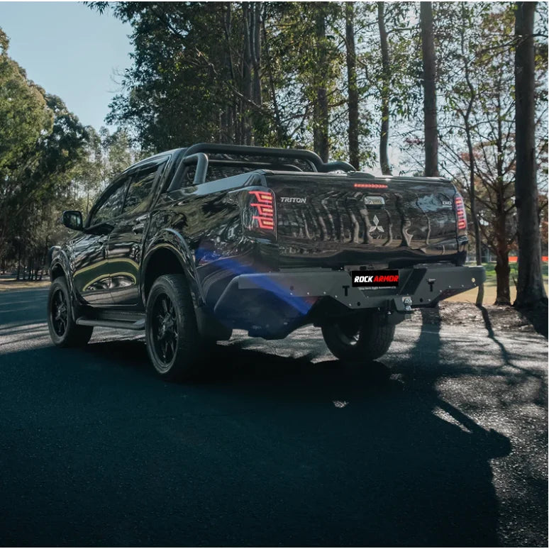 Black Mitsubishi Triton mq 2015-2018 fitted with rockarmor elite steel rear step and elite rear tow bar at the back side