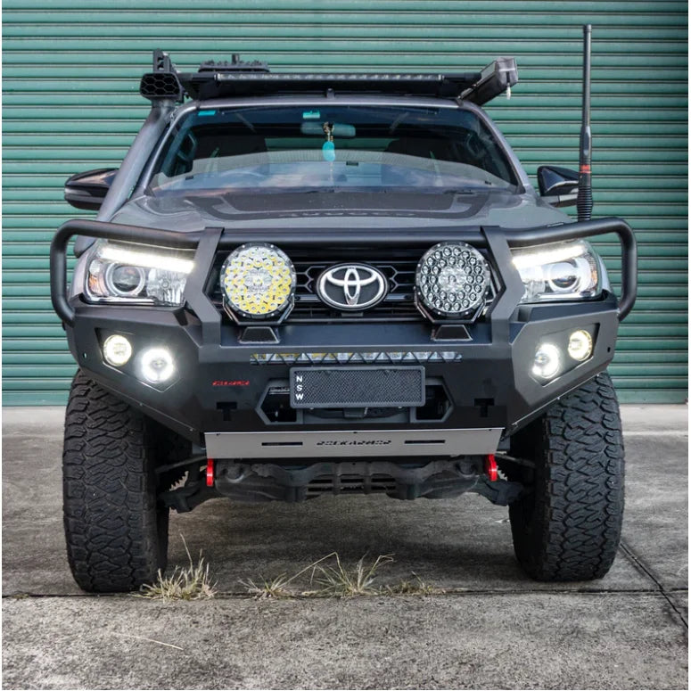 Gray Toyota Hilux equipped with rockarmor gt hoop steel bullbar featuring aftermarket bumper, lights, and rated recovery points