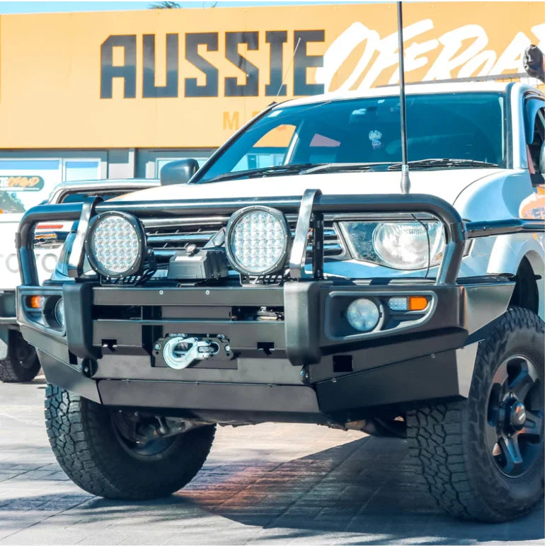 White off-road mitsubishi triton with black rockarmor premium bullbar featuring synthetic winch rope for protection