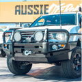 White mitsubishi triton equipped with rockarmor premium steel bullbar featuring black bull bar and led fog lights