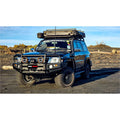 Black nissan patrol gu4 with rockarmor premium steel bullbar and roof rack featuring led fog lights
