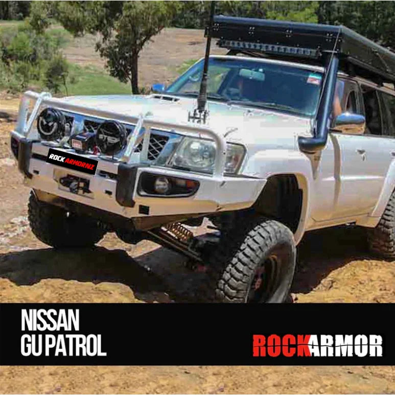 White nissan patrol gu4 equipped with rockarmor premium steel bullbar featuring led fog lights for off-road protection