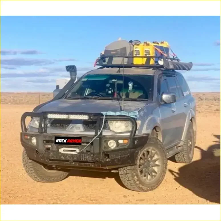 Dark gray mitsubishi triton challenger with black premium bullbar and roof rack carrying yellow gear from rockarmor rock pack