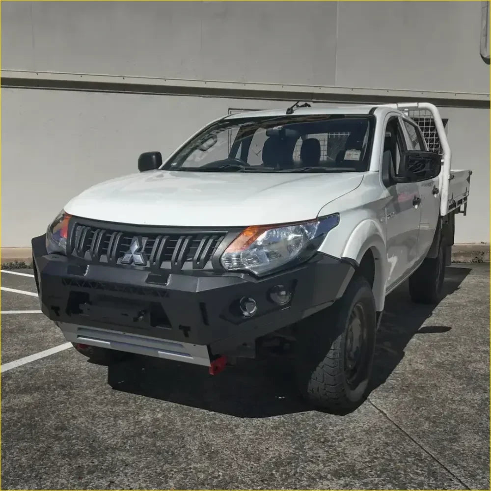 White mitsubishi triton with black gt hoopless bullbar and rock sliders from rockarmor rock pack set up