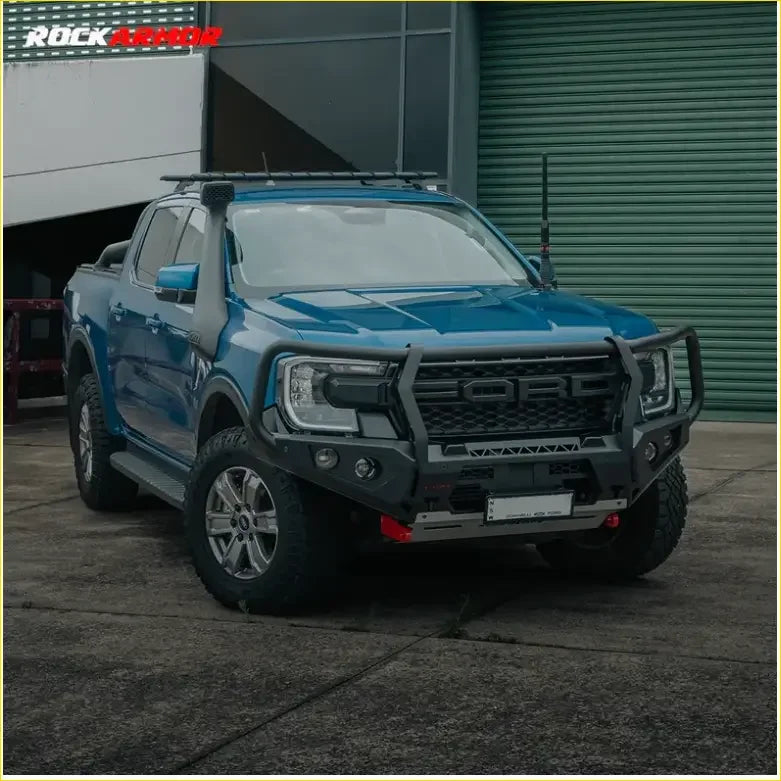 Blue ford ranger with black rockarmor gt hoop bullbar roof rack and rock sliders for offroad protection