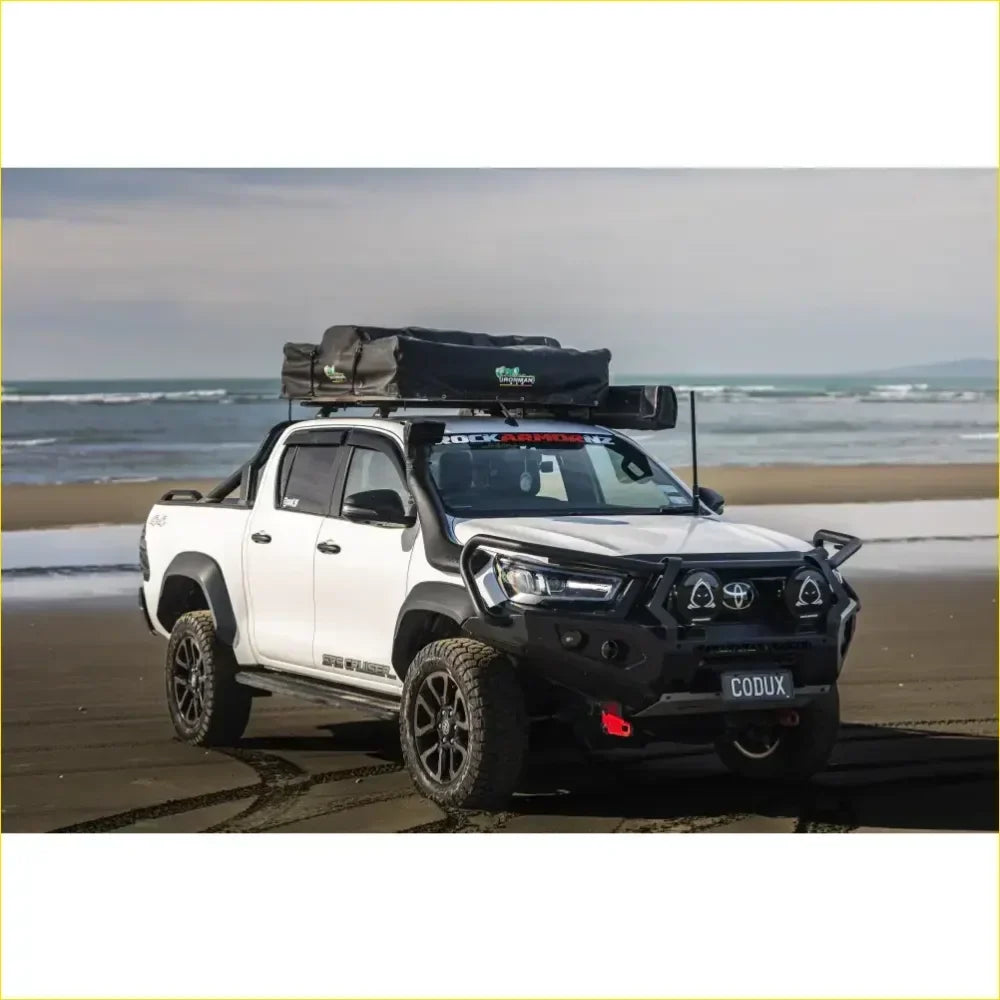 White toyota hilux 2022 widebody with black rockarmor gt hoop bullbar rock sliders and rooftop tent from back side
