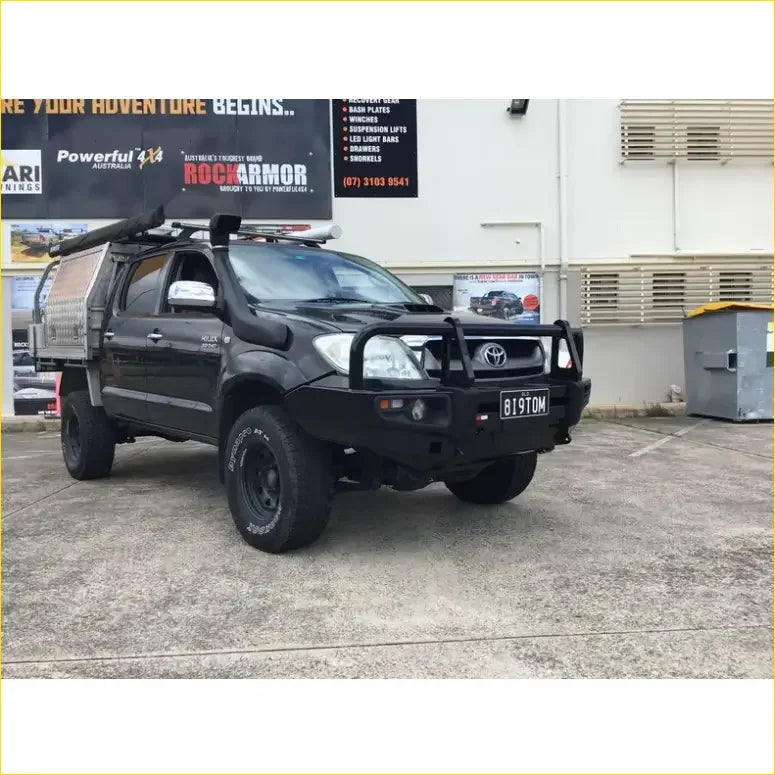 Black Toyota Hilux N70 2005-2011 with Rockarmor Rock Pack premium bullbar roof rack and rugged off-road rock sliders