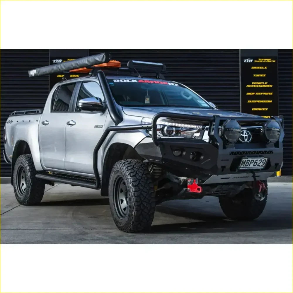 Silver Toyota Hilux pickup with black Rockarmor Rock Pack N80 bullbar and rock sliders for off-road use