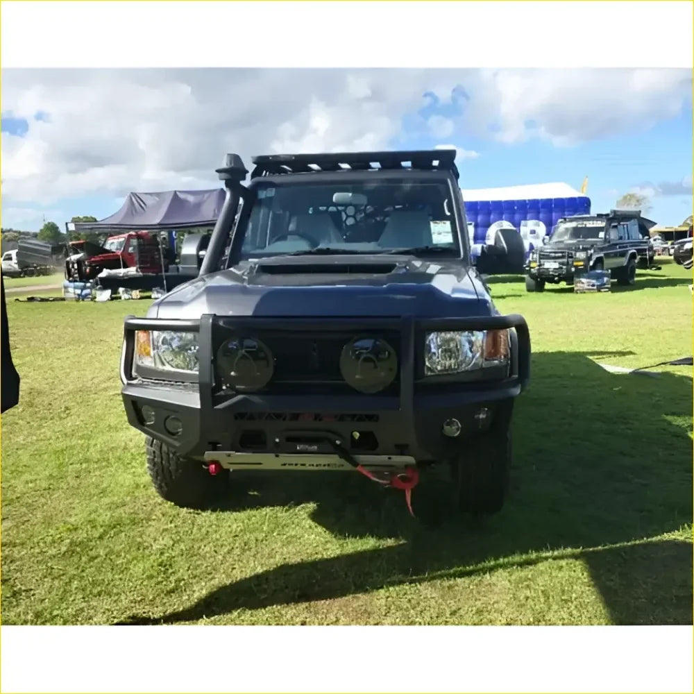 Black armored Toyota Landcruiser 79 with gt hoop bullbar and roof rack for off-road protection and utility