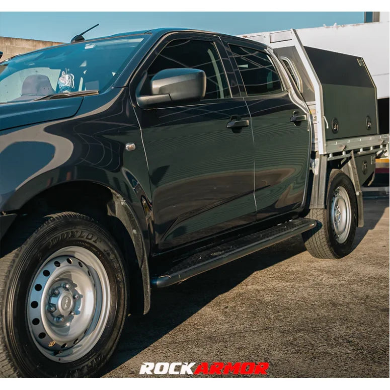 Black Isuzu Dmax 08/20+ pickup truck with 52mm diameter steel rock sliders Rockarmor side steps visible from the back side