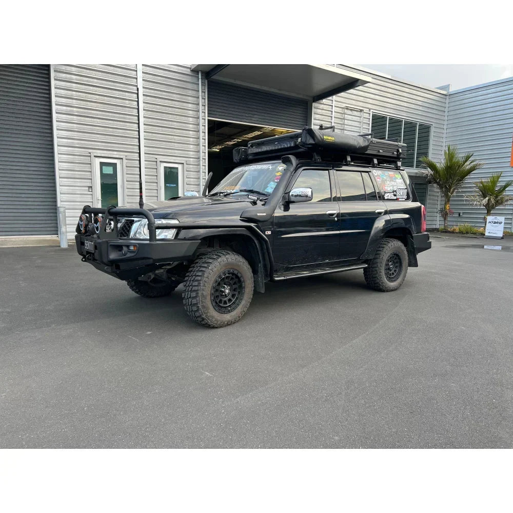 Black off-road vehicle with roof tent featuring rockarmor steel rockslider side steps suit nissan patrol y62 v8
