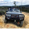 Black off-road Toyota Landcruiser Fj80 equipped with Rockarmor premium steel bullbar and integrated LED fog lights